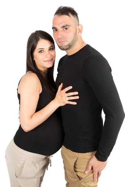 beauty pregnant woman with man standing against white background - Foto, immagini