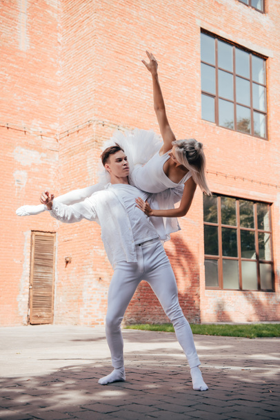 young ballet dancers in white clothes dancing on city street  - Photo, Image