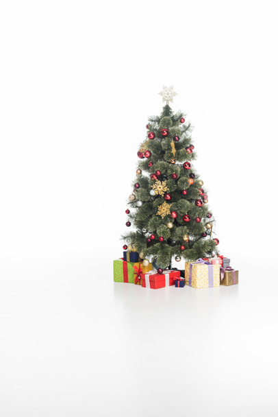 close up view of festive christmas tree and wrapped gifts isolated on white - Фото, зображення