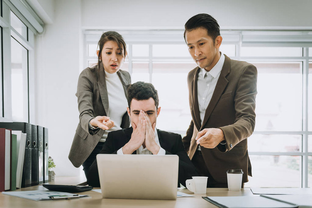 Business people blamimg depressed caucasian man colleague in office. - Photo, Image