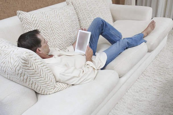 Relaxed Man Using Digital Tablet - Фото, изображение