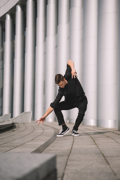 young contemporary dancer in black clothes on street - Fotoğraf, Görsel