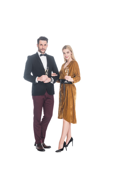 young fashionable couple with glasses of champagne isolated on white - Foto, imagen