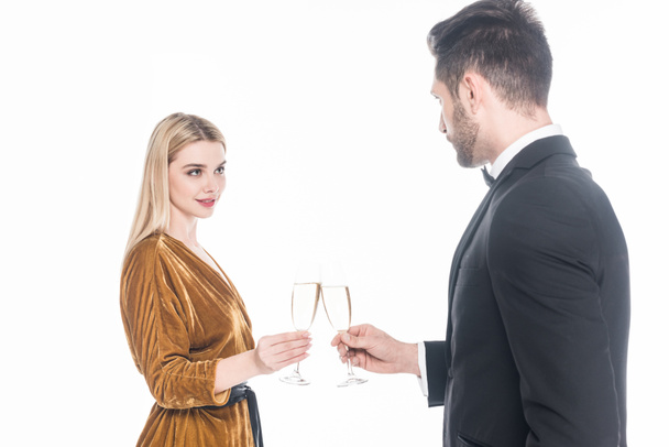 fashionable couple clinking glasses of champagne isolated on white - Фото, изображение