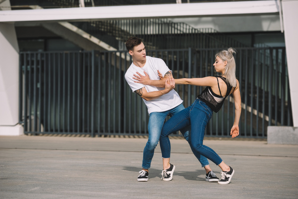 young couple of contemporary dancers practicing on urban city street   - Фото, зображення