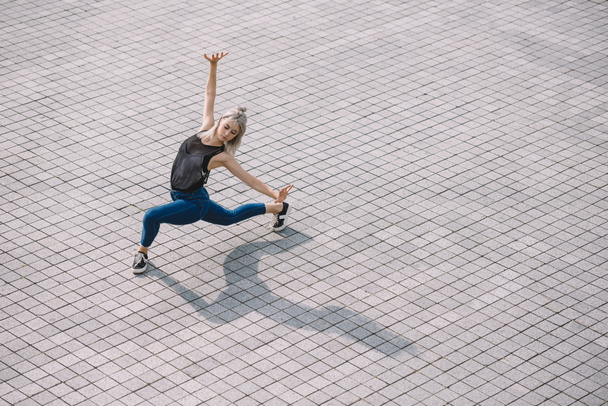 high angle view of beautiful girl performing contemporary dance on street   - Fotografie, Obrázek