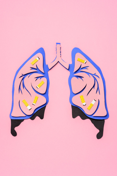 top view of human lungs with cigarettes on pink, lung cancer awareness concept - Photo, Image