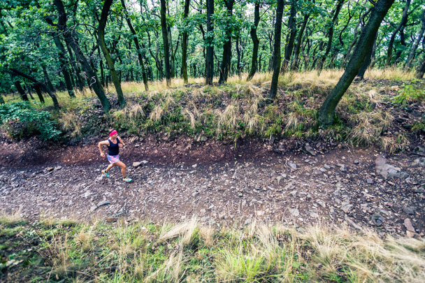 Trail running athletic woman in green forest, sports inspiration and motivation. Female trail runner cross country running. Fitness concept outdoors in nature. - 写真・画像