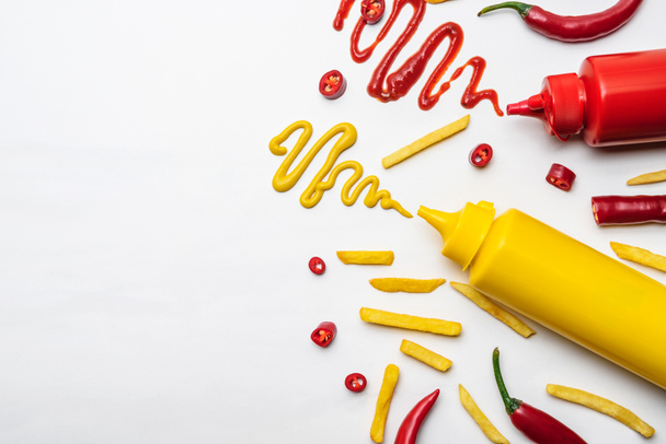 top view of french fries with mustard and ketchup on white surface - Photo, Image