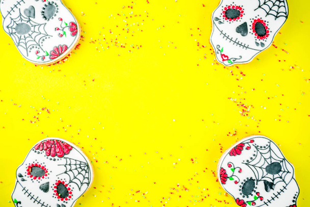 Dia de Los Muertos, Mexican Day of the Dead or Halloween greeting card background with traditional colorful skull shaped cookies with sugar topping candies top view copy space - Photo, Image