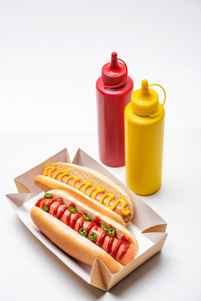 close-up shot of tasty hot dogs with mustard and ketchup on white - Fotografie, Obrázek