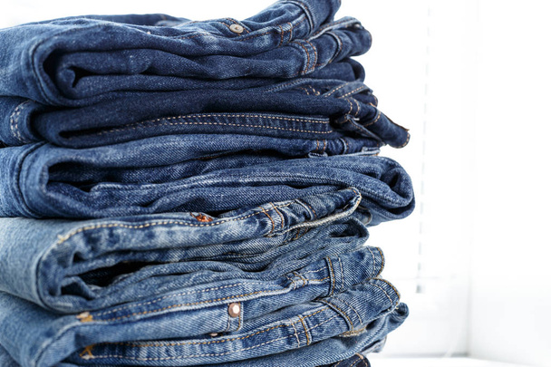 Pile of blue casual jeans, close-up  - Fotó, kép