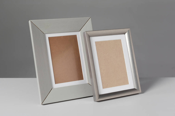 Different empty photo frames on table - Foto, imagen