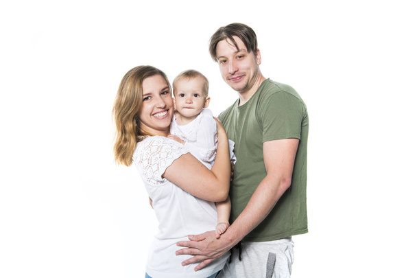 Mother, father and small daughter on studio white - Foto, Imagen