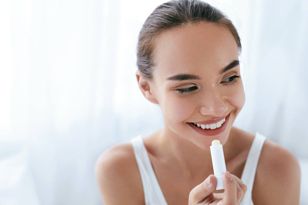 Lips Skin Care. Beautiful Woman Applying Lip Balm. Beauty - Fotó, kép
