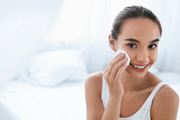 Makeup Remove. Girl Cleaning Face Skin With Cosmetic Pad - Photo, image