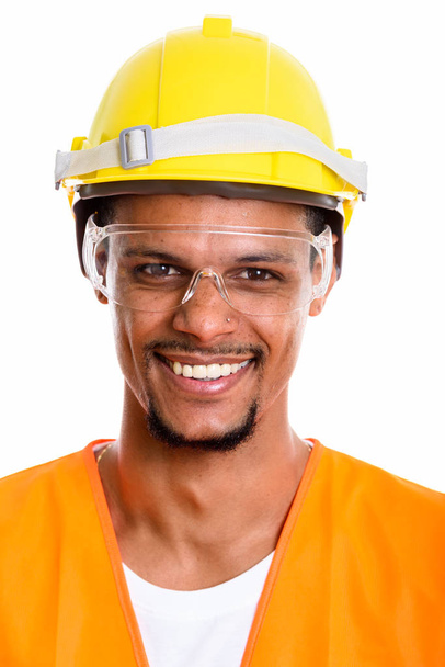 Gezicht van gelukkig Afrikaanse man bouwvakker glimlachen terwijl slijtage - Foto, afbeelding