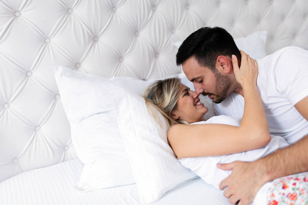 Happy young couple having romantic times in bedroom - Фото, изображение