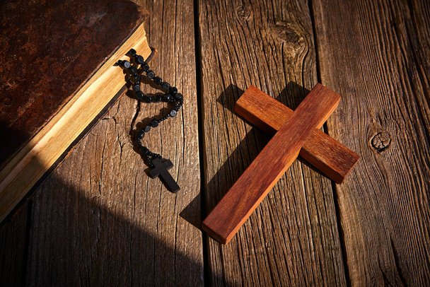 Christian cross on wood bible and rosary beads over wooden vintage background - Fotografie, Obrázek