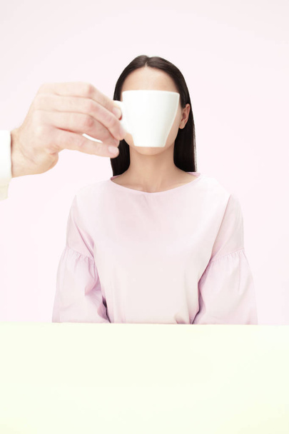 The coffee break concept. woman before drinking coffee sitting indoor at table at studio - Φωτογραφία, εικόνα