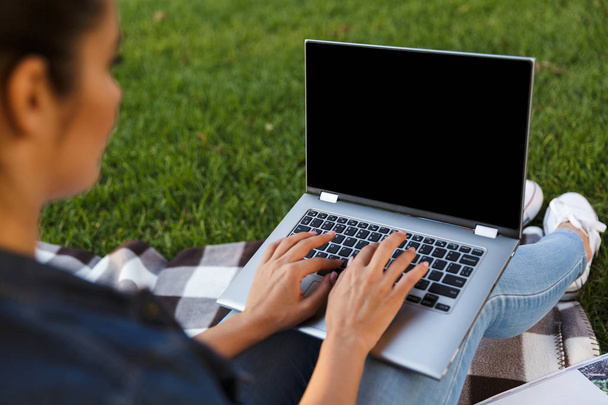 Cropped image of amazing beautiful young woman student in the park using laptop computer. - Foto, immagini