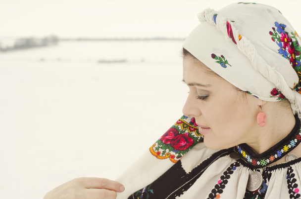 Woman in traditional ukrainian cloth on snow - Fotó, kép