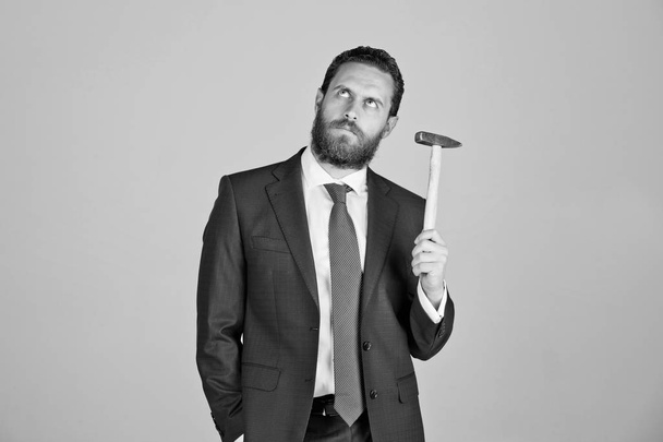 determined businessman with hammer in hands, business and success - Fotografie, Obrázek