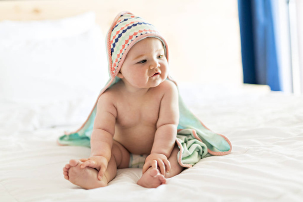 beautiful baby girl in the bed at home with - Foto, imagen