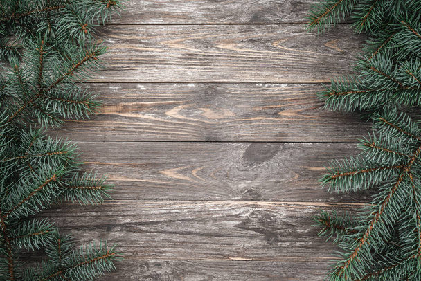 Old wood background with fir branches. Space for a greeting message. Christmas card. Top view. - Zdjęcie, obraz