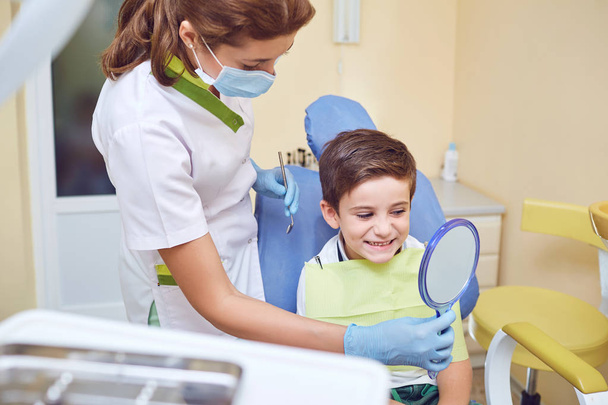 A child with a dentist in a dental office.  - Фото, зображення