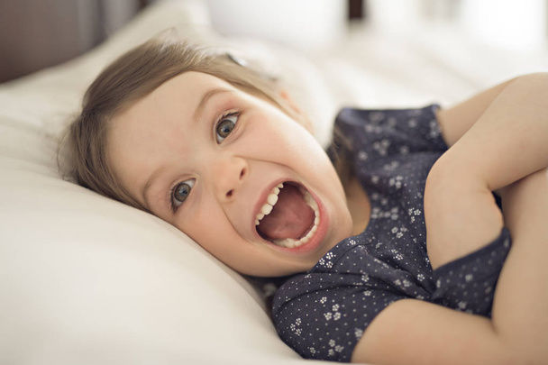 A cute Little beautiful girl on bedroom - Фото, изображение