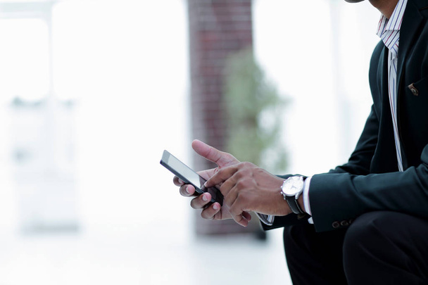 closeup. employee typing SMS on the smartphone - Foto, Imagen