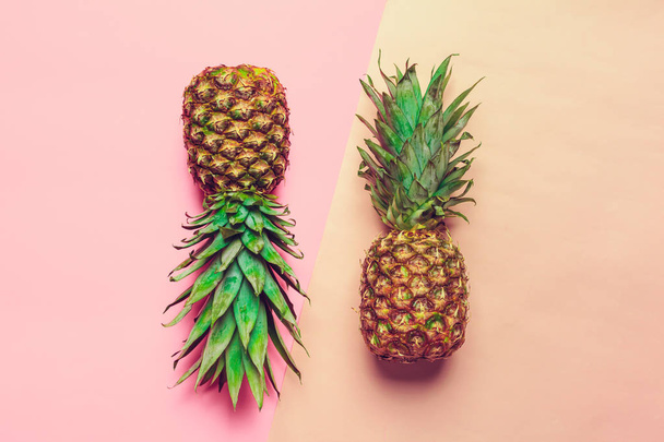 top view of pineapples on colored paper background  - Photo, image