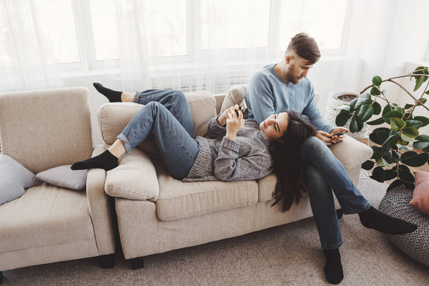 Couple in living room using smart phones - Photo, Image