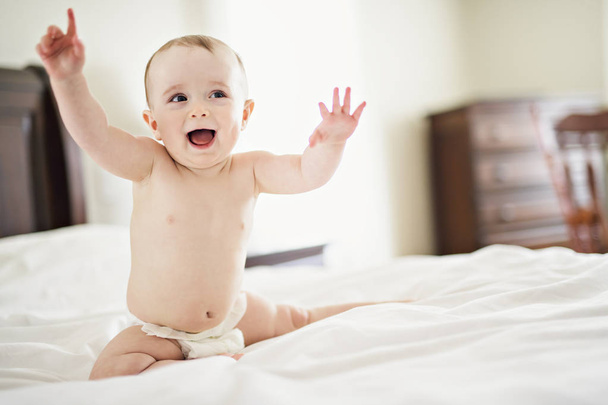 Portrait of a baby on the bed - Foto, imagen