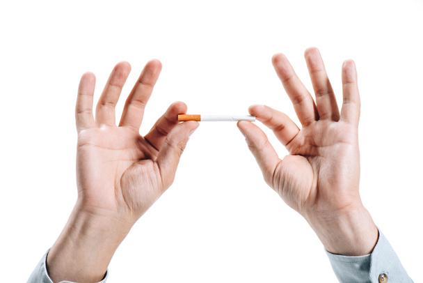 cropped image of man holding unhealthy cigarette isolated on white - Photo, image