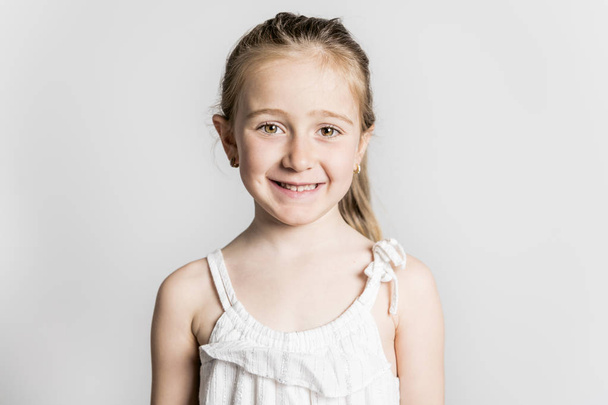 A beautiful little fashion model child on white background - Foto, imagen