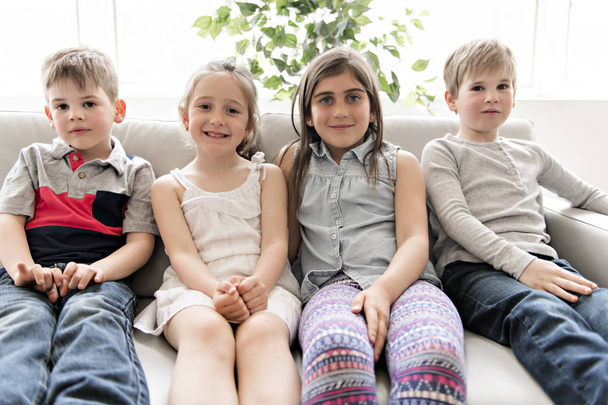 Group Of Young Friends Together on the sofa listening tv - Foto, afbeelding
