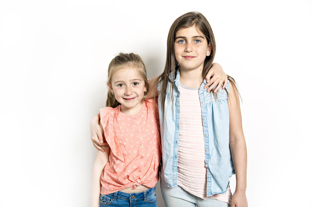 Two Sisters portrait in studio white background - Photo, image