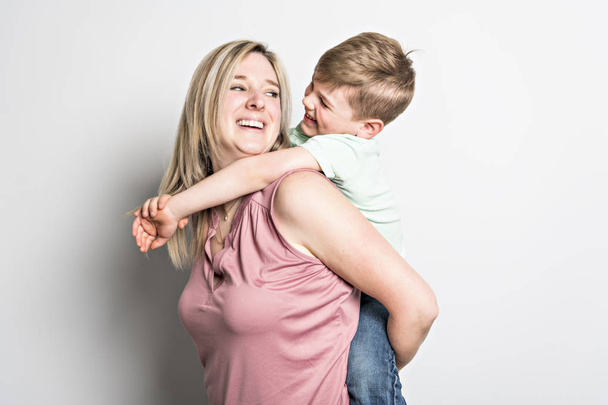Mother and son on studio white background - 写真・画像