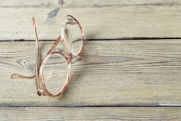 close up of eyeglasses on wooden table - Foto, Imagem