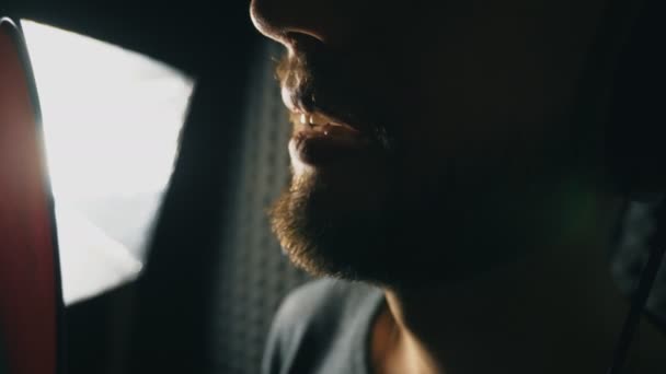 Mouth of male singer singing in sound studio. Unrecognizable man recording new song. Guy with beard sings to microphone. Working of creative musician. Show business concept. Slow motion Close up - Footage, Video