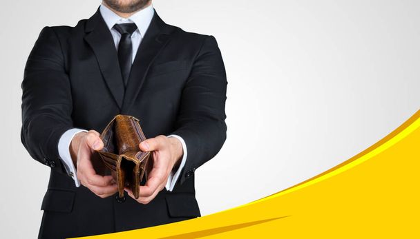 Unrecognizable businessman showing you empty wallet. Business concept - Photo, Image