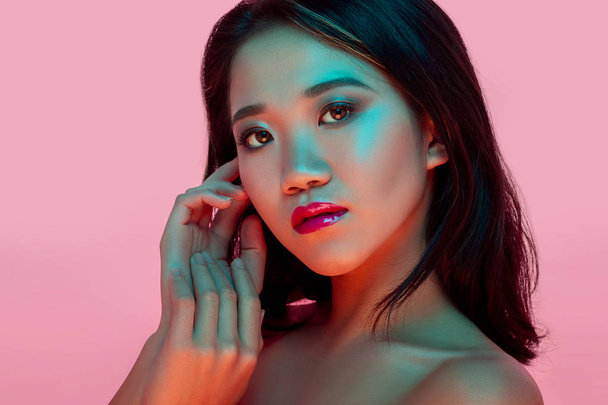 High Fashion model woman in colorful bright lights posing in studio - 写真・画像