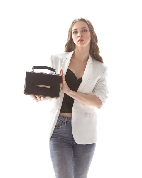 stylish young woman showing her fashionable handbag.isolated on white - Фото, зображення