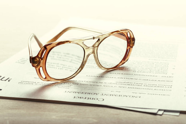 Close up shot of Eyeglasses  on contract document papers, business concept - Photo, Image