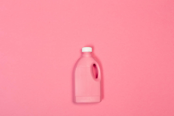 Colored plastic bottle on pink background  - Фото, изображение