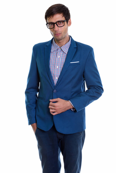 Studio shot of young handsome businessman standing while holding - Foto, Imagen