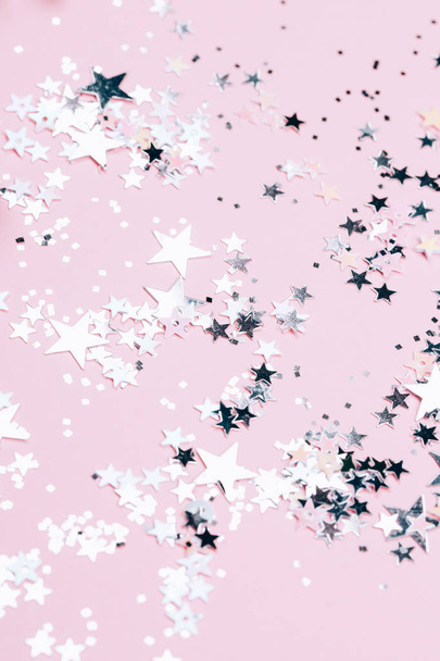 Silver sparkles, stars and glitters on pink background. Festive concept. - Φωτογραφία, εικόνα