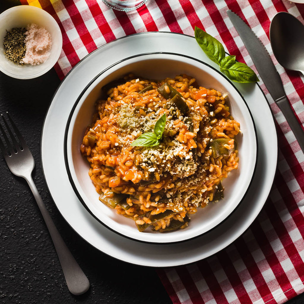Italian risotto with tomato sauce on the table. - Foto, afbeelding